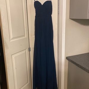 This is a small navy blue strapless dress. It has never been worn before.